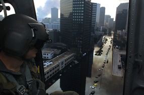 person in helmet in view of flooded city, usa, louisiana, new orleans