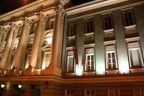 classic building with columns at night, fragment of facade