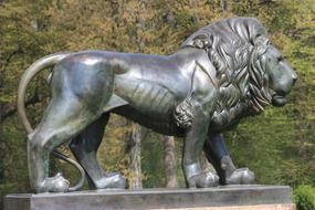 lion, metal statue in park, side view