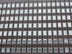 lattice windows on grey bricks facade of chile house, germany, hamburg