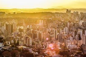 aerial view of beautiful modern city in sunset sun rays