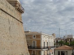 historic wall of aged stone tower in town