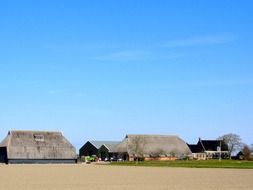 farm buildings and tractors in countryside, netherlands