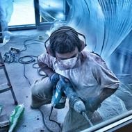 worker in mask with hammer drill, demolition