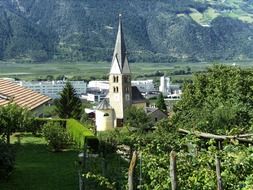 vineyard and church in town at green mountain, italy, vetzan