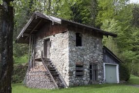 old wild stone house among trees