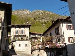 houses with balconies at mountain side, italy, pregasina