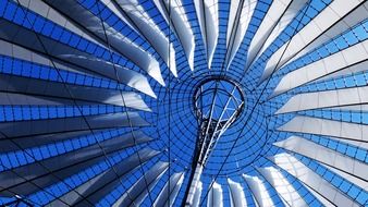 bottom view of glass and metal roof construction of sony center, germany, berlin