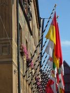 row of colorful flags on old facade