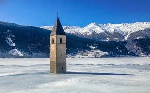 steeple in Lake Reschen at winter, italy, south tyrol