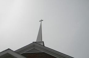 cross on the roof of the church