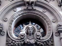 stone woman bust, decoration atop door