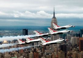 squadron of fighter jets in sky at empire state building, usa, nyc