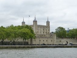 view of Tower of London from thames river, uk, england