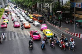 colorful cars and scooters on road in city, thailand, bangkok