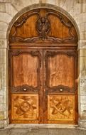 old wooden door with carved ornament, france, larochelle