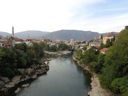 beautiful old town on both sides of river at mountains, bosnia and herzegovina, mostar