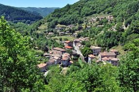 old village in green valley at summer, france, albon d'ardeche