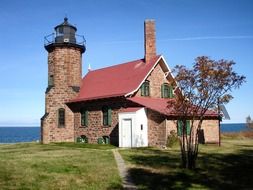 sand island lighthouse, brick building at sea, usa, wisconsin