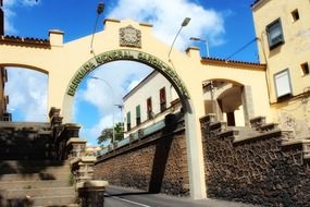 tenerife street arch buildings clouds blue sky
