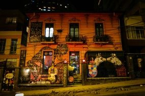 fantasy graffiti on facade of old building at night, bolivia, la paz