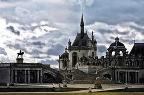 walk path and stairway to chapel in Chantilly at cloudy day, france