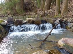 Clean waterfall among stones in the forest