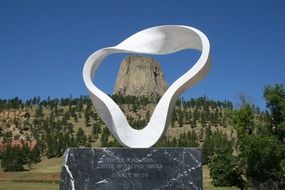 White modern sculpture at devil’s tower rock formation, usa, wyoming