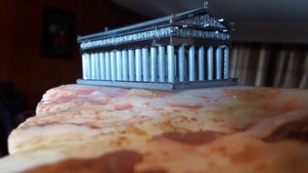 closeup picture of parthenon temple model on stone surface