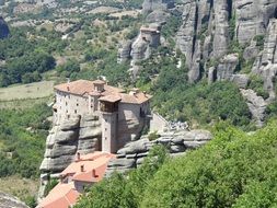 top view of ancient monastery on rock in greece, meteora