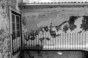 balcony at grunge painted wall in patio of house, black and white