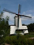 windmill in front of forest at summer, netherlands, niederrhein