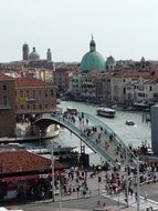 people walking on constitution bridge in city, italy, venice