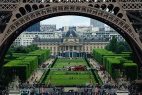 a view of the Champ de Mars through the Eiffel Tower