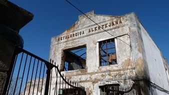 lapsed factory building with broken windows and roof