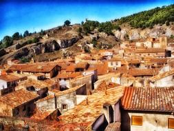 red clay tile rooftops of houses on hill side, spain, daroca