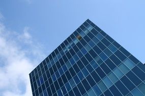 diagonal view of blue skyscraper top part