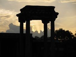 silhouette of historic building with columns at sunset sky, india, belur