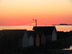 village houses near water at sunset, norway