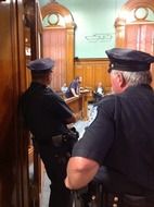 police officers at door of city council during meeting