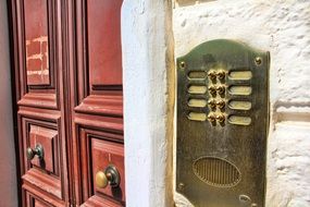 metal doorbell red wood entrance door