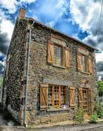 old two-storey stone house with lattice windows, france, saillant