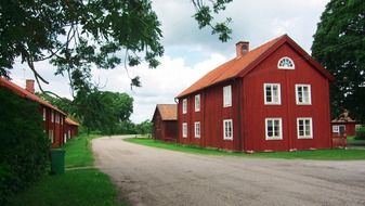 red houses on roadside in village at summer, sweden