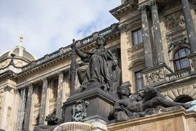 Black bronze statue on old building