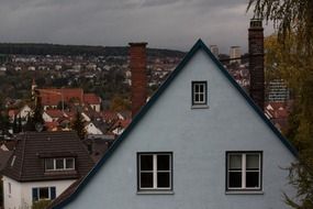 house with roof windows in old town on rainy weather at autumn