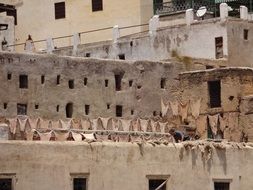 man at work on traditional tannery, morocco, medina