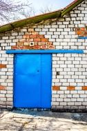 closed blue metal door of warehouse