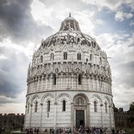 tourists near Baptistery at evening, italy, pisa