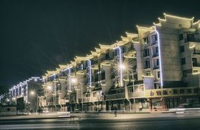 Modern lightened building, night view, traffic