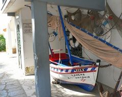 sailing boat and nets at fisherman house, portugal